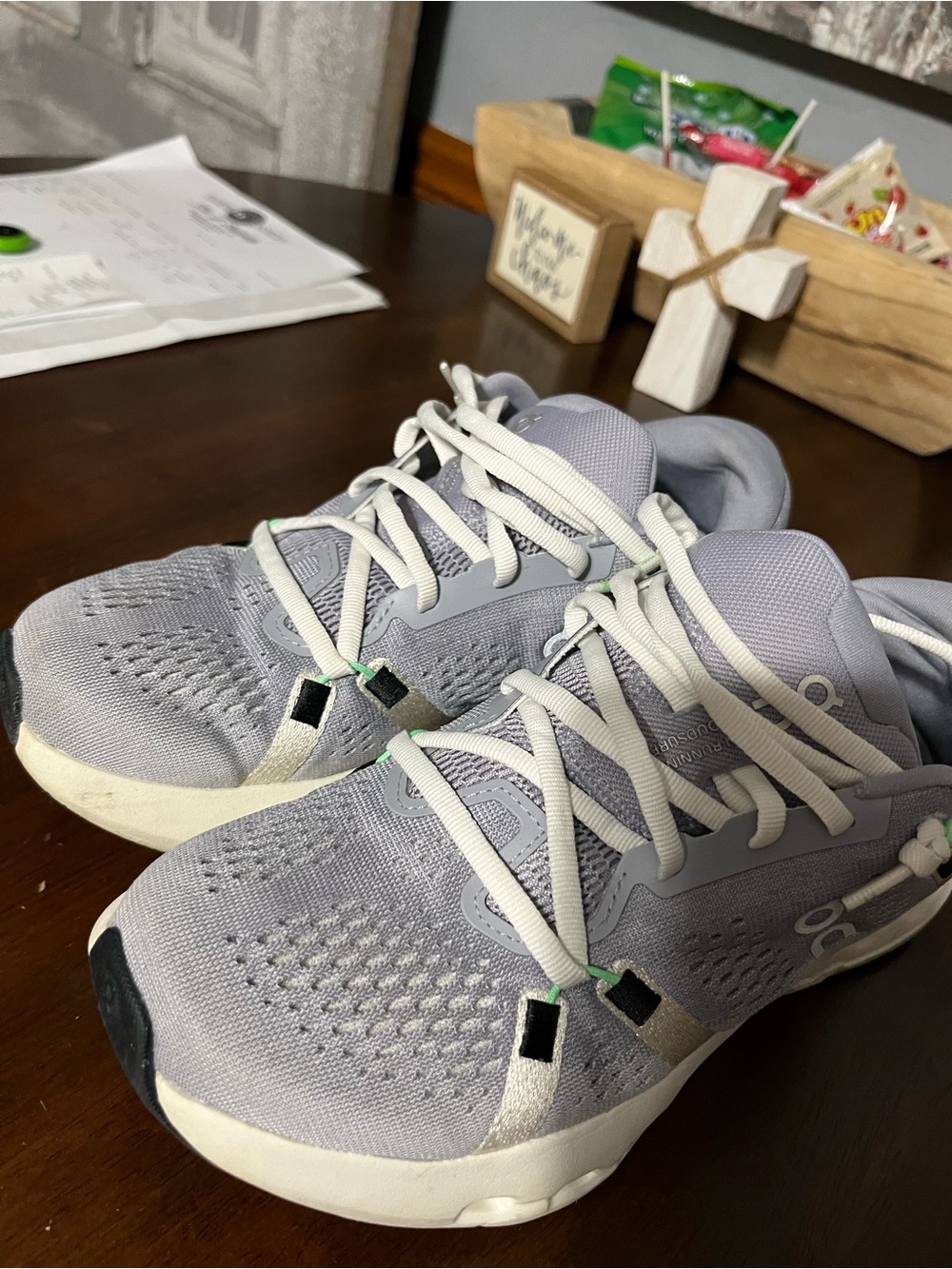 On Running White Sneakers with Green and Black Accents